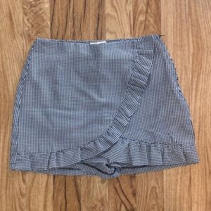 black & white checkered shirt. Pleated.